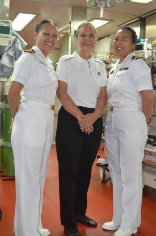 Professor Kristine Qureshi smiles with service members 