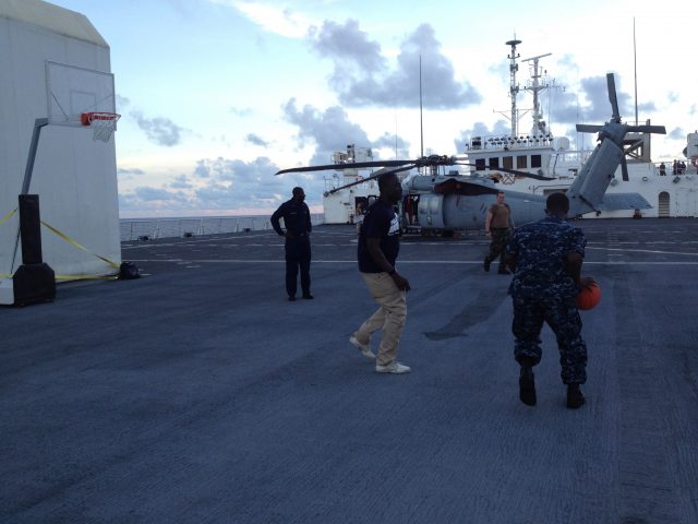 Pick-up basketball game between Navy and NGO volunteers on board ship
