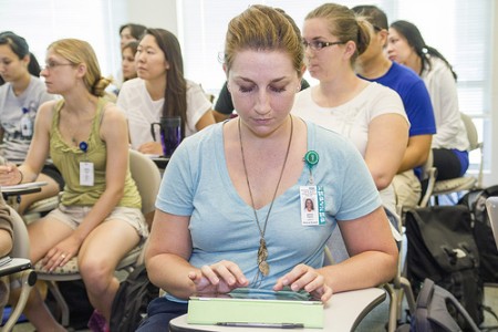 student takes notes on ipad during lecture 