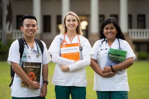 Nursing students standing outside of Hawaii Hall at UH Manoa