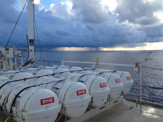 photo of life raft pods Lined up along the deck, with an endless Pacific Ocean as a backdrop.