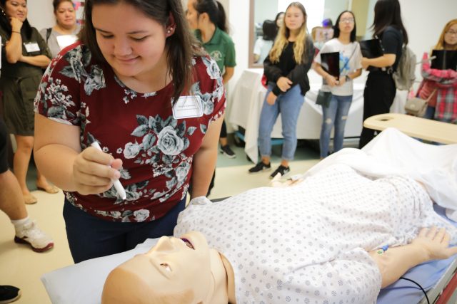 students interact with the dummy patient