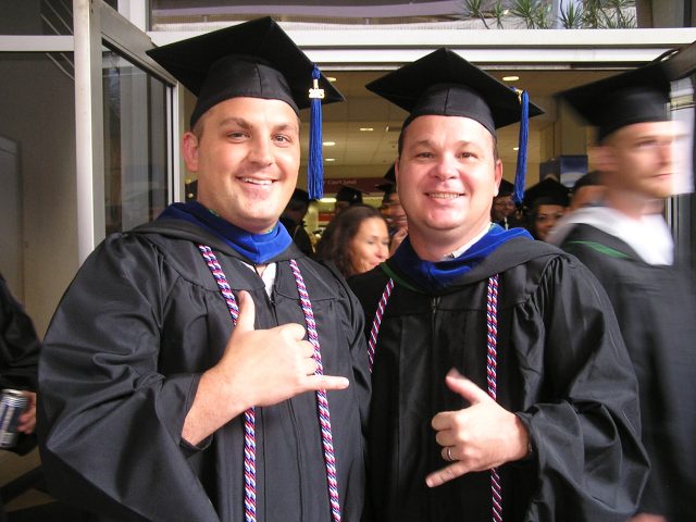 UH Manoa veteran graduates smile for photo 