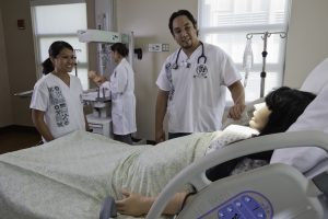 students interact with dummy patient at UHM Nursing THSSC_Labor and Delivery