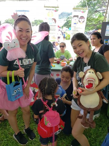 dental hygiene students providing education to kids