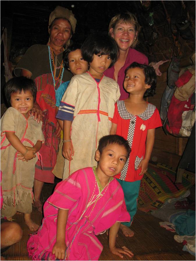 Sharon Jensen smiles around thai children 