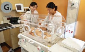 students practice with newborn incubator